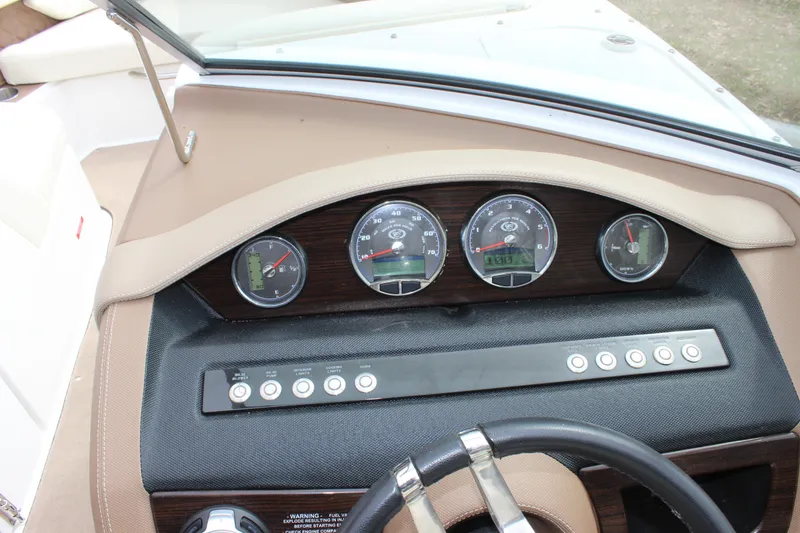 Slide: The Image of Dashboard of a 2012 Cobalt A25 boat with gauges and controls. - 24