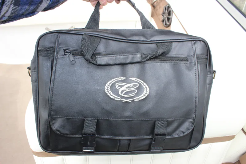 Slide: The Image of Black Cobalt A25 bag with embroidered logo, 2012 model, held by a hand. - 26