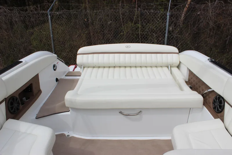 Slide: The Image of 2012 Cobalt A25 boat interior with white leather seating and speaker system. - 28