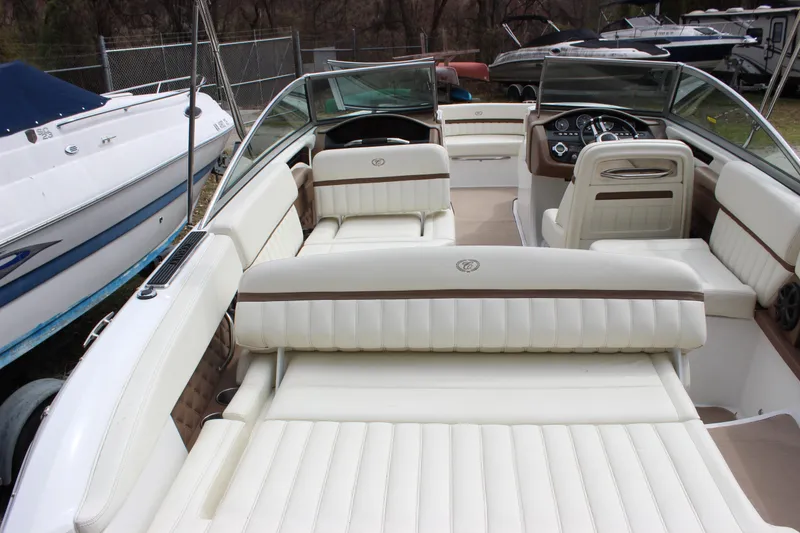 Slide: The Image of 2012 Cobalt A25 boat interior with white leather seating and dashboard view. - 34