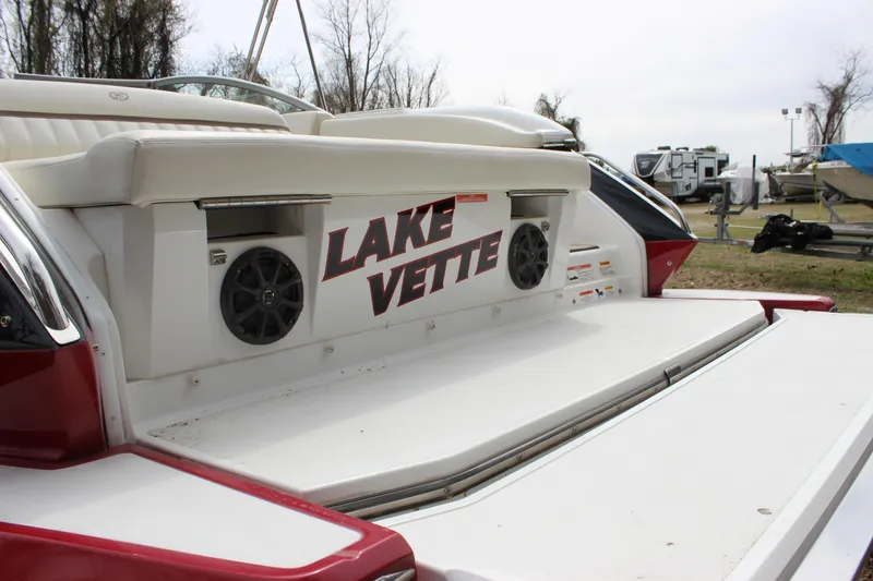 Slide: The Image of 2012 Cobalt A25 boat with "Lake Vette" text on rear deck, outdoor setting. - 36