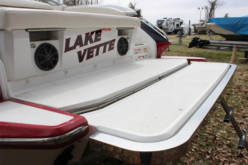 Slide: The Image of 2012 Cobalt A25 boat with "Lake Vette" decal and rear speakers, parked outdoors. - 37
