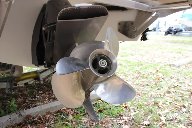 Slide: The Image of Close-up of a 2012 Cobalt A25 boat propeller on a grassy surface. - 38