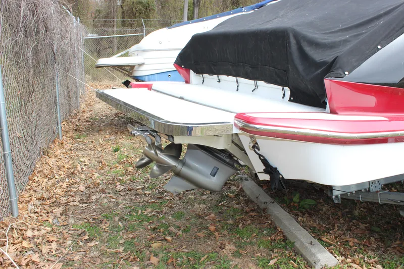 Slide: The Image of 2012 Cobalt A25 boat with covered stern, parked on leaf-covered ground. - 42