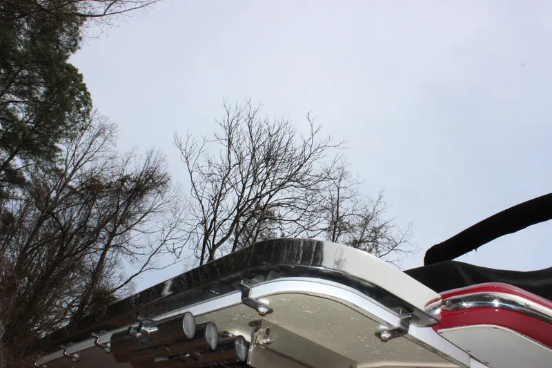 Slide: The Image of Rear view of a 2012 Cobalt A25 boat against a backdrop of trees and sky. - 45