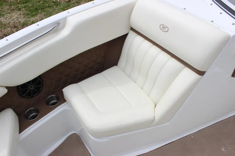 Slide: The Image of Luxurious white seating in a 2012 Cobalt A25 boat, featuring cup holders and speaker. - 5