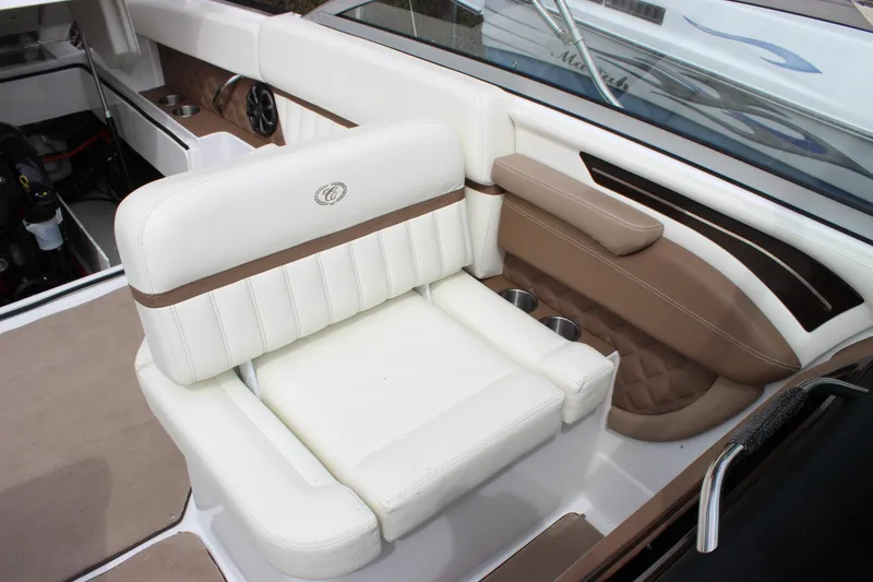 Slide: The Image of Luxurious seating in a 2012 Cobalt A25 boat, featuring white and brown upholstery. - 7