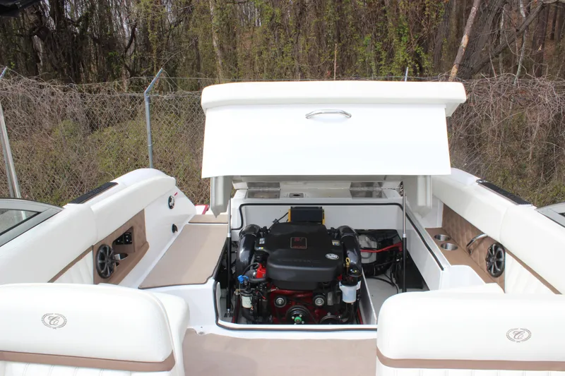 Slide: The Image of 2012 Cobalt A25 boat engine compartment with open hatch, showcasing interior mechanics. - 8