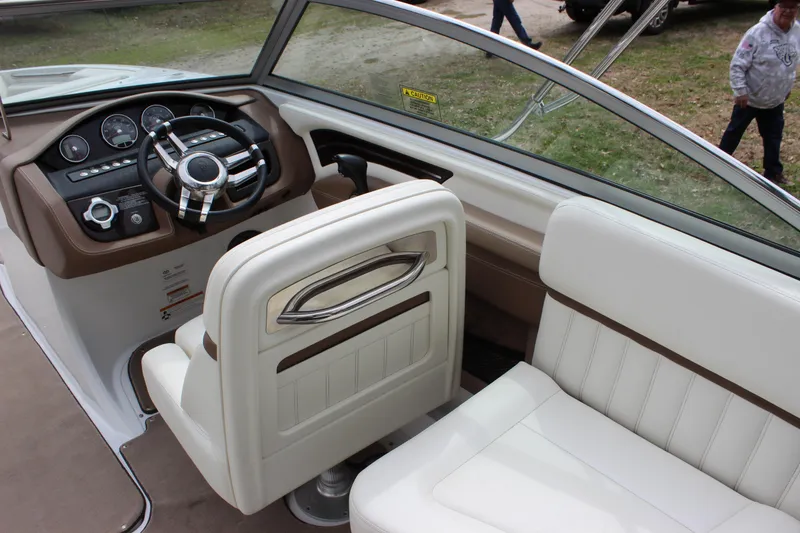 Slide: The Image of Interior of 2012 Cobalt A25 boat with steering wheel and white seating. - 9