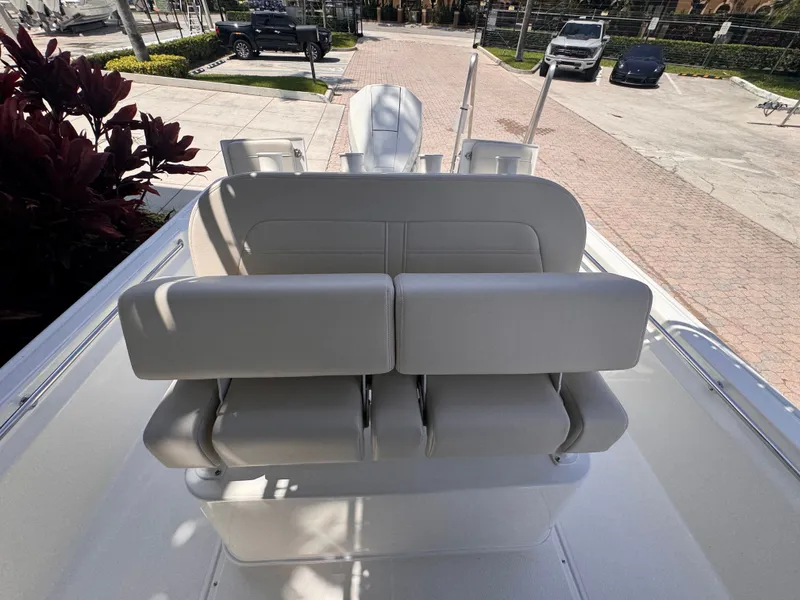 Slide: The Image of The image shows the rear of a Boston Whaler 210 Montauk boat with cushioned seats. - 20