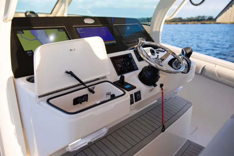 Slide: The Image of Manufacturer Provided Image: 2025 Scout 425 LXF boat helm with advanced navigation technology and sleek design. - 7