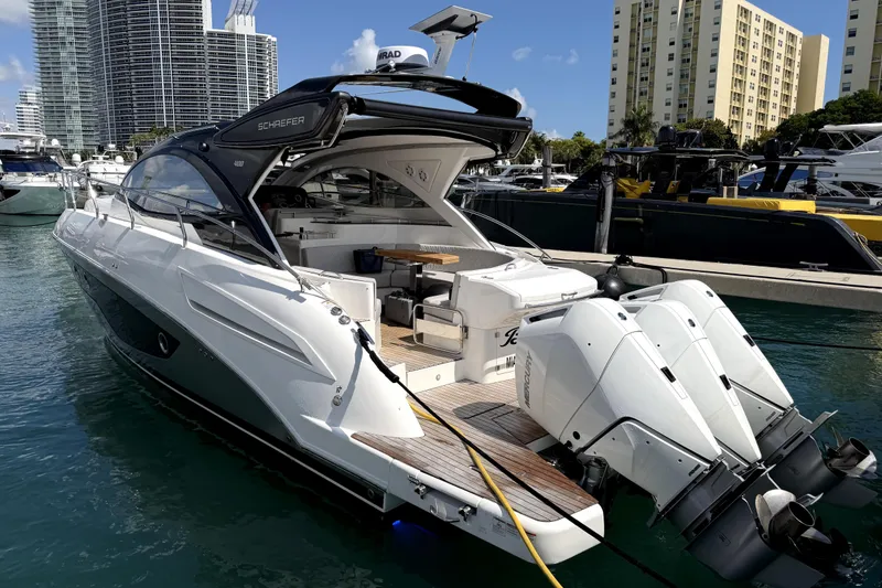 The Image of 2024 Schaefer 400 yacht docked in marina, featuring sleek design and powerful outboard engines. - 0