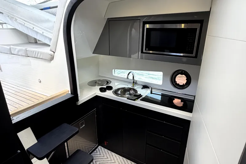 Slide: The Image of Modern kitchen area in 2024 Schaefer 400 yacht with microwave and sink. - 14