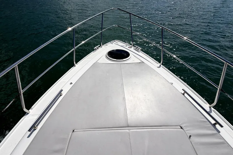 Slide: The Image of Bow view of 2024 Schaefer 400 yacht on water, featuring sleek design and railing. - 8