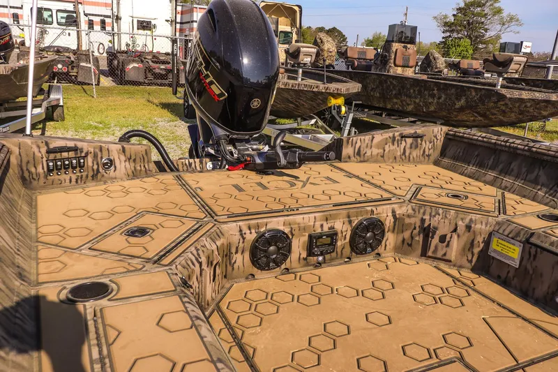 Slide: The Image of 2026 Excel 183 Tomahawk boat with camo design and powerful outboard motor. - 11