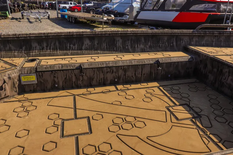 Slide: The Image of 2026 Excel 183 Tomahawk boat interior with geometric patterns and storage compartments. - 13