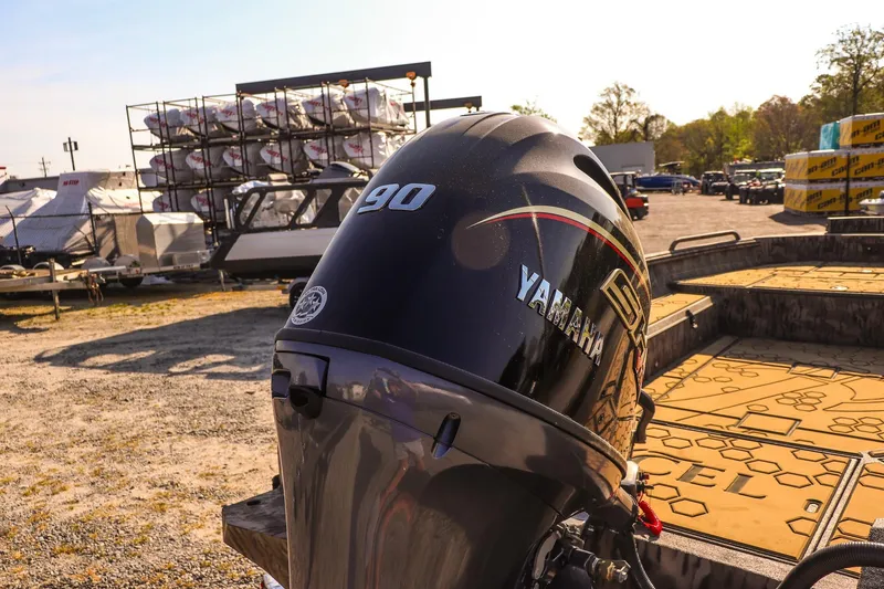 Slide: The Image of Outboard motor on Excel 183 Tomahawk boat, 2026 model, in a sunny outdoor setting. - 16