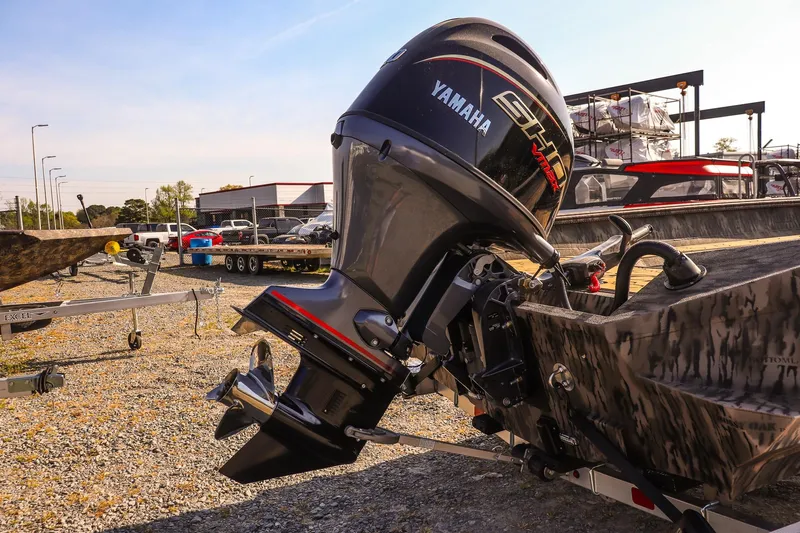 Slide: The Image of 2026 Excel 183 Tomahawk boat with Yamaha outboard motor in a dealership lot. - 17