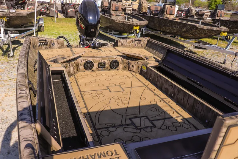 Slide: The Image of 2026 Excel 183 Tomahawk boat interior with camo design and storage compartments. - 18