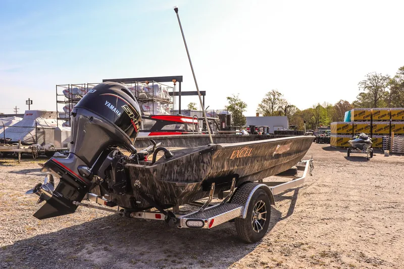 Slide: The Image of 2026 Excel 183 Tomahawk boat with Yamaha engine on trailer in outdoor setting. - 3