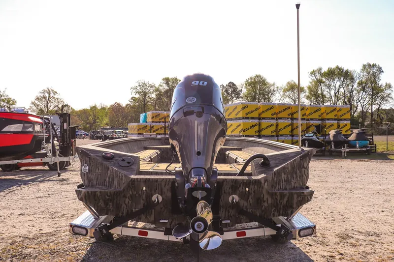 Slide: The Image of 2026 Excel 183 Tomahawk boat with 90 HP engine on a trailer, outdoor display. - 4