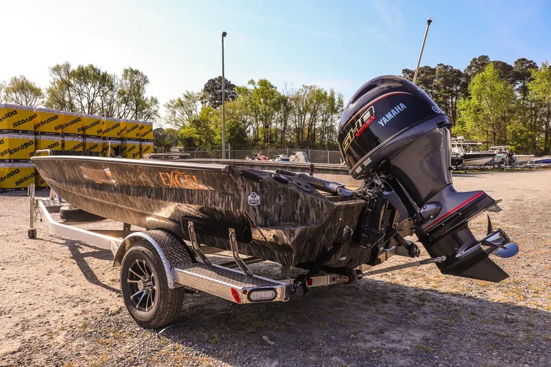 Slide: The Image of 2026 Excel 183 Tomahawk boat with Yamaha motor on trailer in sunny outdoor setting. - 5