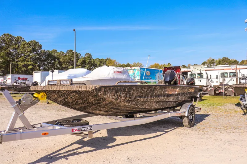 Slide: The Image of 2026 Excel 183 Tomahawk boat on trailer in outdoor lot. - 7