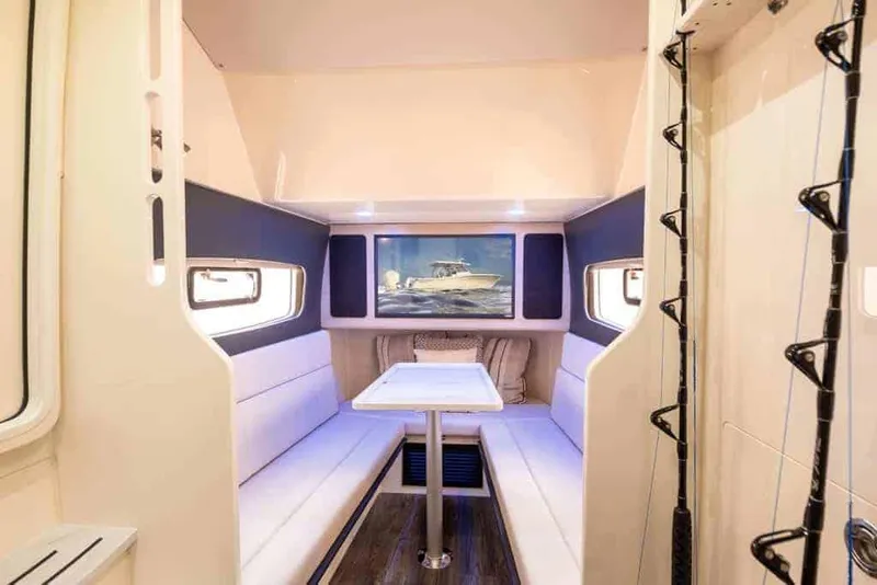 Slide: The Image of Manufacturer Provided Image: Luxurious interior of 2025 Scout 400 LXF Li-Ion boat with seating and table. - 11