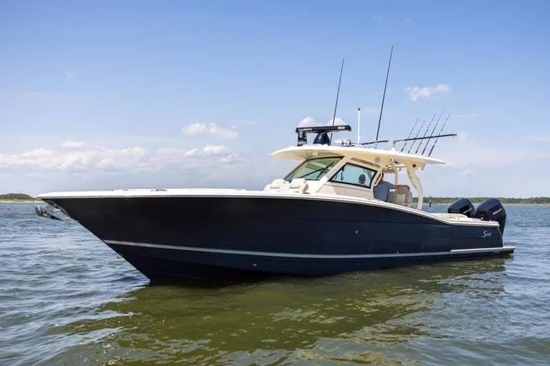 Slide: The Image of Manufacturer Provided Image: 2025 Scout 400 LXF Li-Ion boat on water, sleek design, clear sky. - 3