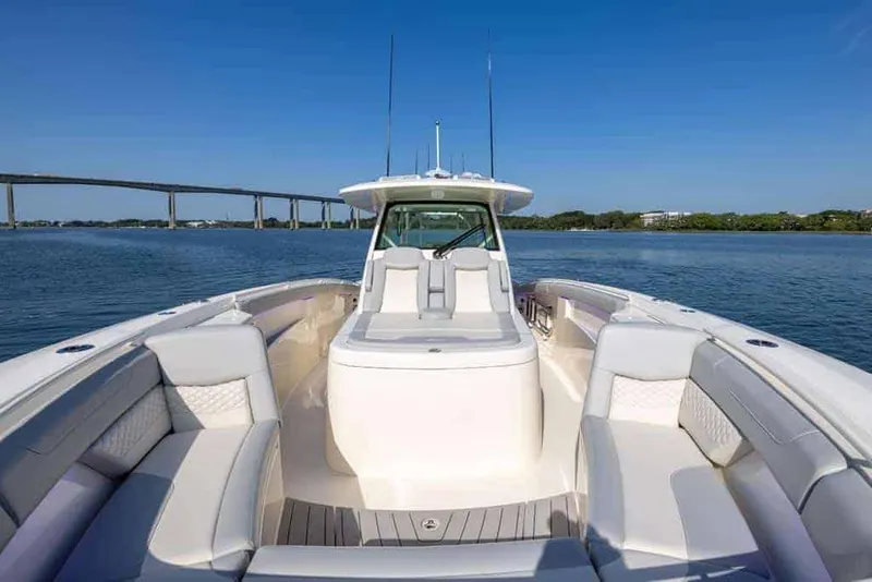 Slide: The Image of Manufacturer Provided Image: 2025 Scout 400 LXF Li-Ion boat on calm water, featuring spacious seating and sleek design. - 5