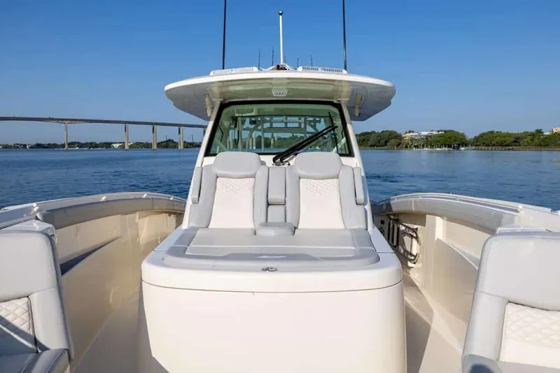 Slide: The Image of Manufacturer Provided Image: 2025 Scout 400 LXF Li-Ion boat on calm water with bridge in background. - 6