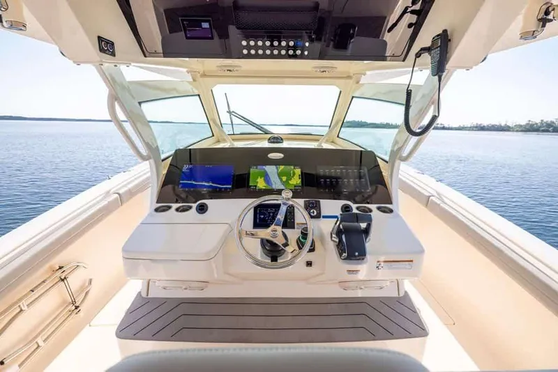 Slide: The Image of Manufacturer Provided Image: 2025 Scout 400 LXF Li-Ion boat cockpit with advanced navigation system and steering wheel. - 7