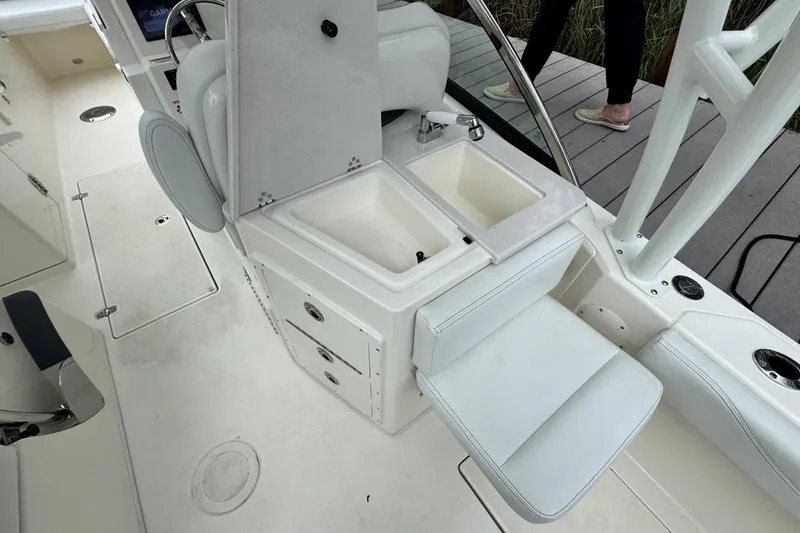 Slide: The Image of 2026 Cobia 240 Dual Console boat interior with sink and seating area. - 10