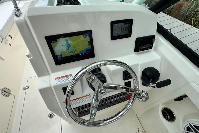 Slide: The Image of Steering console of 2026 Cobia 240 Dual Console boat with navigation display. - 12