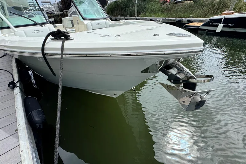 Slide: The Image of 2026 Cobia 240 Dual Console boat docked, showcasing sleek design and stainless steel anchor. - 21