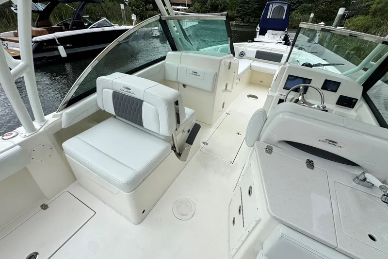 Slide: The Image of 2026 Cobia 240 Dual Console boat interior with seating and helm. - 9