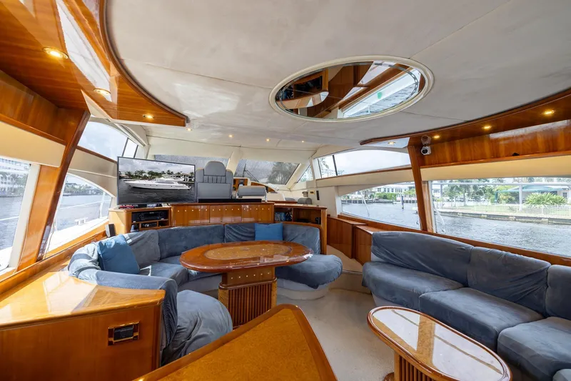 Slide: The Image of Luxurious interior of a 1999 Azimut 58 yacht with plush seating and elegant wood finishes. - 12