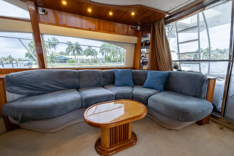 Slide: The Image of Luxurious interior of a 1999 Azimut 58 yacht with plush seating and wooden accents. - 13