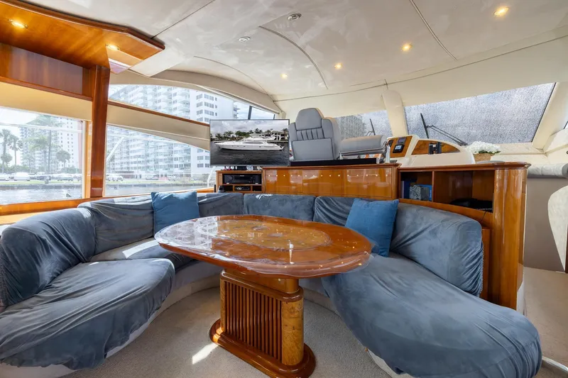 Slide: The Image of Luxurious interior of a 1999 Azimut 58 yacht with plush seating and elegant wood finishes. - 14