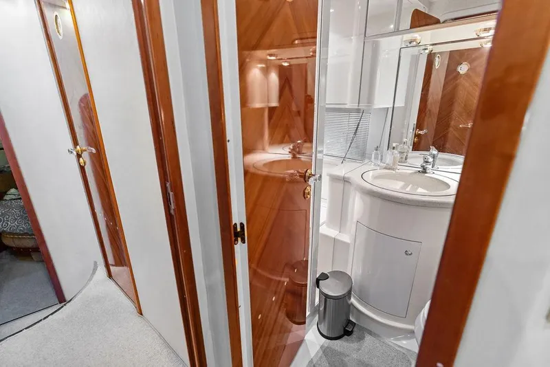 Slide: The Image of Luxurious bathroom interior of a 1999 Azimut 58 yacht, featuring elegant wood accents. - 15
