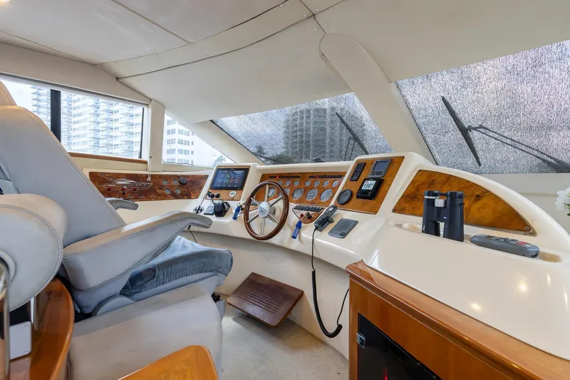 Slide: The Image of Cockpit of 1999 Azimut 58 yacht with steering wheel and navigation instruments. - 16