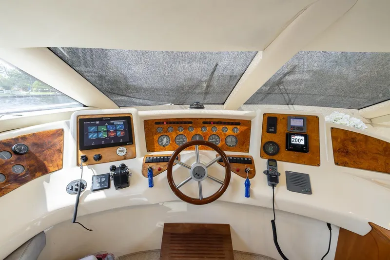 Slide: The Image of Cockpit of a 1999 Azimut 58 yacht with navigation instruments and steering wheel. - 17