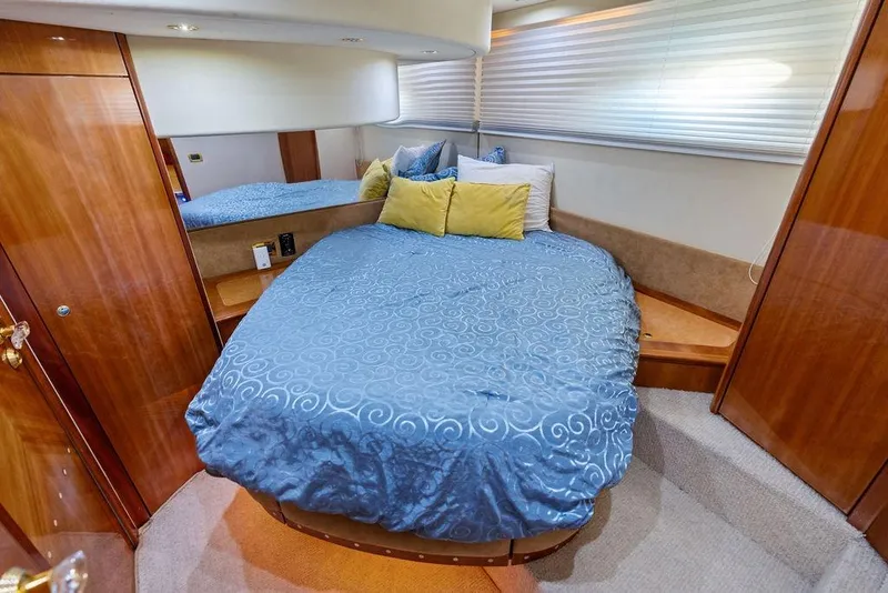Slide: The Image of Luxurious bedroom interior of 1999 Azimut 58 yacht with elegant wood finishes. - 18