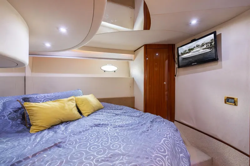 Slide: The Image of Luxurious bedroom interior of 1999 Azimut 58 yacht with elegant bedding and wall-mounted TV. - 19