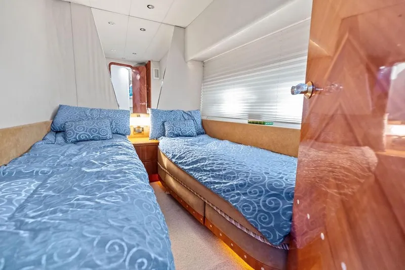 Slide: The Image of Interior of 1999 Azimut 58 yacht with twin beds and blue bedding. - 20