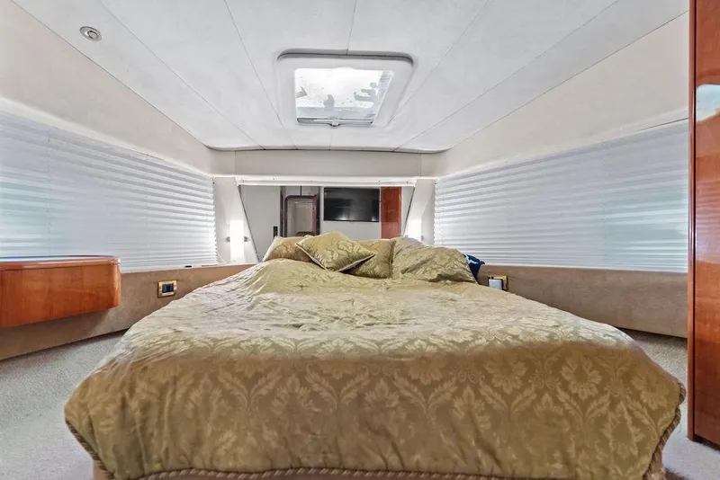 Slide: The Image of Luxurious bedroom interior of a 1999 Azimut 58 yacht with elegant bedding. - 26