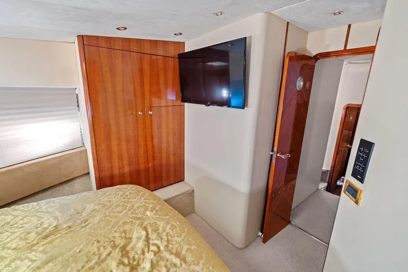 Slide: The Image of Luxurious interior of a 1999 Azimut 58 yacht with wood paneling and modern amenities. - 27
