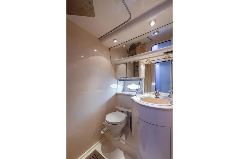 Slide: The Image of Luxurious bathroom in a 1999 Azimut 58 yacht, featuring modern fixtures and elegant design. - 31