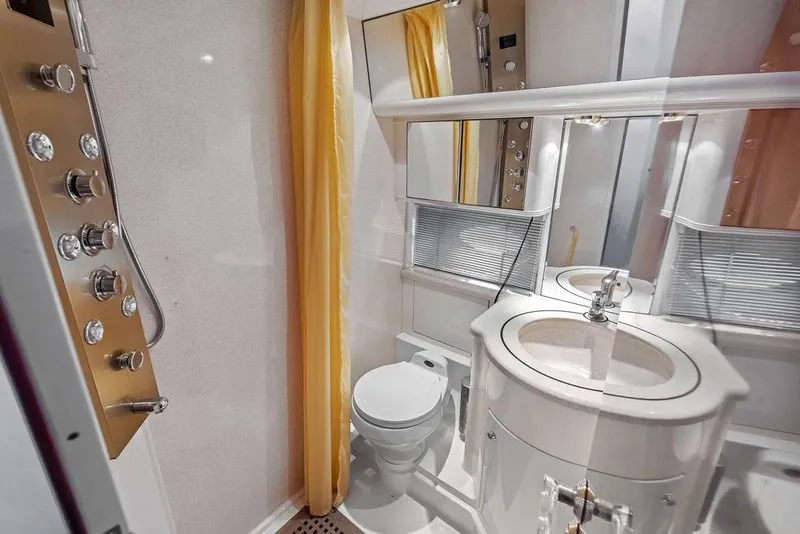 Slide: The Image of Luxurious bathroom in a 1999 Azimut 58 yacht, featuring modern fixtures and elegant design. - 39