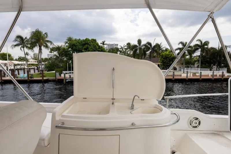 Slide: The Image of Luxury yacht Azimut 58 (1999) with outdoor sink, dockside view, and palm trees. - 40